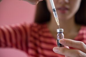 woman-putting-vaccine_1150-13855